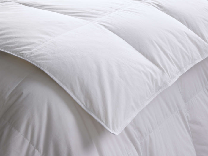 Close-up of a folded white Down Duvet Insert, showing its thick, fluffy texture and square baffle-block quilting.