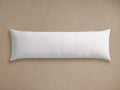 White Down Fill Lumbar Pillow Insert, rectangular and soft, lying horizontally on a textured light beige background.