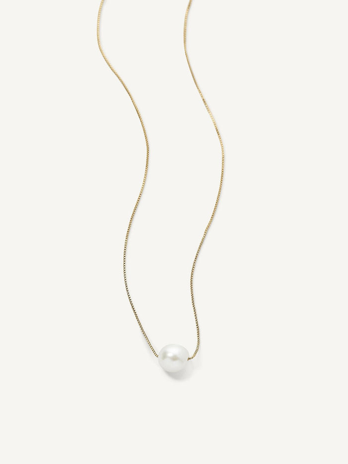 A single freshwater pearl pendant necklace on a gold-plated chain, presented against a white background.