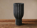 Edel Ruffle Vase, dark gray, textured, with vertical ridges, standing upright on a rustic wooden table.