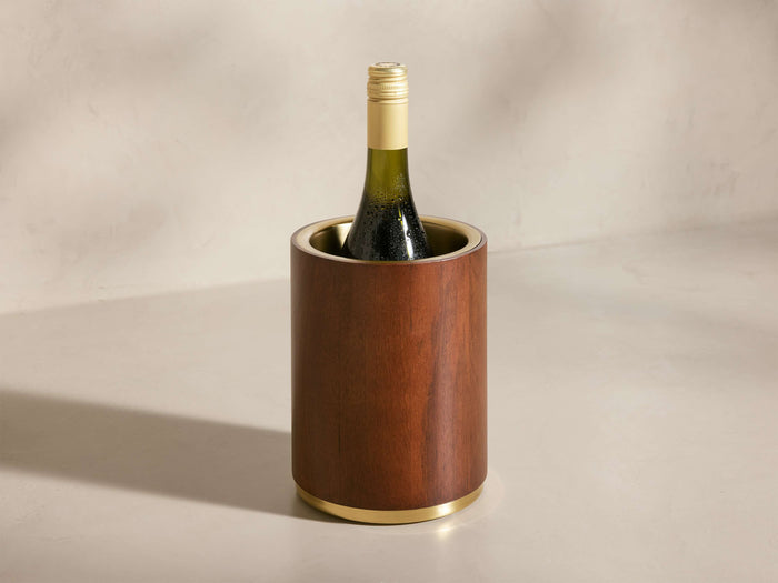 Front view of the brown wooden Errol Wine Chiller with gold accents, holding a chilled white wine bottle.