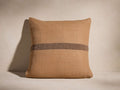 Esencia Stripe Pillow: Tan woven pillow with subtle herringbone texture, featuring a dark brown horizontal stripe.