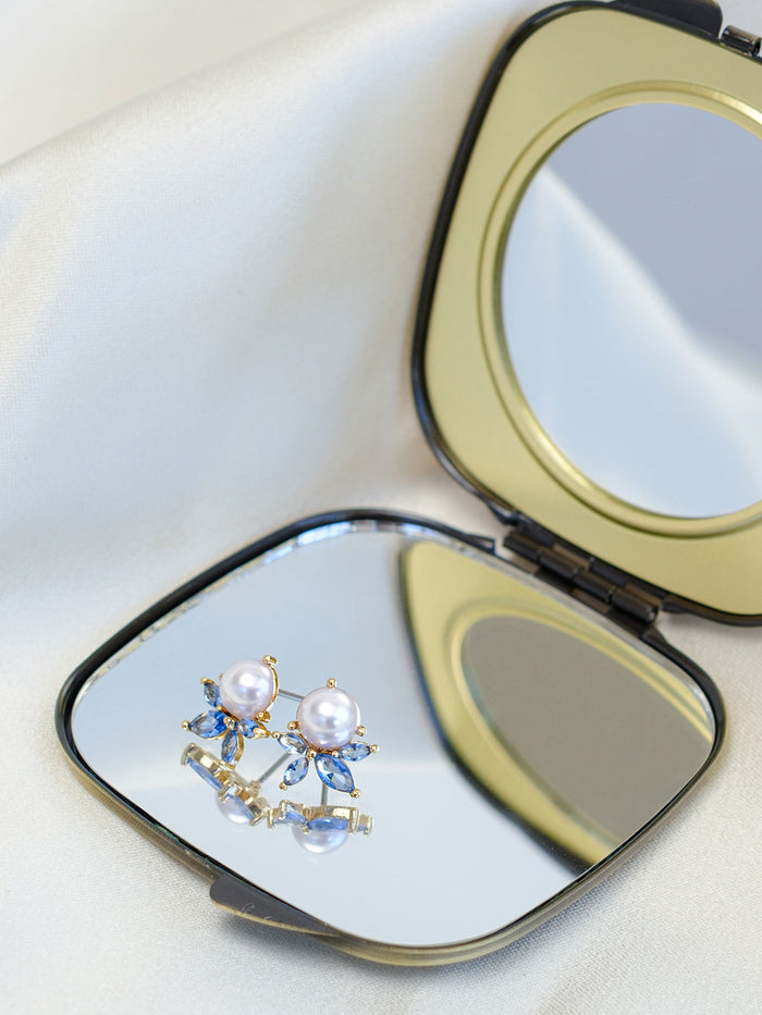 Ever Blue Studs on a compact mirror