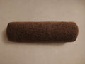 Horizontal dark brown Faux Sherpa Bolster Pillow, cylindrical, with plush, textured faux fur on a light tan background.