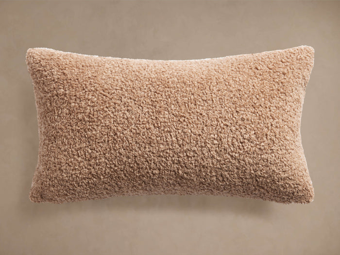 Faux Sherpa Lumbar Pillow Cover in Dune, a light brown, rectangular pillow with a plush, fuzzy faux fur texture.