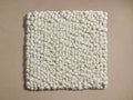 Freemont Rug Swatch: Square, off-white with dense, pebble-like texture on a light beige background.