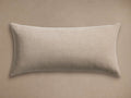 Light beige Granville Outdoor Lumbar Pillow, horizontally oriented, with a subtle woven texture, against a tan background.