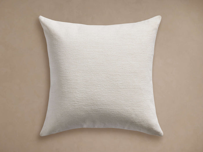 Granville Outdoor Pillow: Square, off-white cushion with a subtle horizontal woven texture, centered on a plain light tan background.