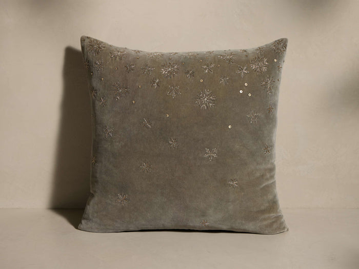 Front view of a taupe Hand-Beaded Snowflake Pillow in velvet, featuring metallic embroidered snowflakes, sequins, and beads.