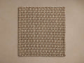 Hatcher Outdoor Rug Swatch. Rectangular, woven swatch in two-tone beige and light brown, laid flat on a light brown surface.