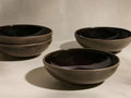 Five dark brown Hearthline Cereal Bowls with glossy black interiors, three stacked left, two separate on the right.