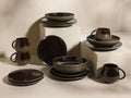 Full display of the chocolate and mocha Hearthline Dinnerware With Pasta Bowls (Set of 16) with reactive glaze.