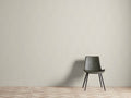 Heath Faux Grasscloth Wallpaper with subtle woven texture in a neutral tone, covering a wall behind a dark green chair on patterned flooring.