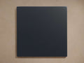 Black square Henley Eclipse Finish Board with smooth texture, centered against a beige background. No visible design elements.