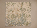 Close-up of the light beige hand-knotted texture with green, blue, and brown abstract patterns on the Holland Hand-Knotted Rug Swatch.