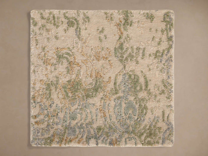 Close-up of the light beige hand-knotted texture with green, blue, and brown abstract patterns on the Holland Hand-Knotted Rug Swatch.