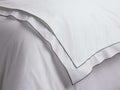 White Italian Embroidered Percale Duvet, folded, showcasing crisp fabric and dark grey embroidered borders.