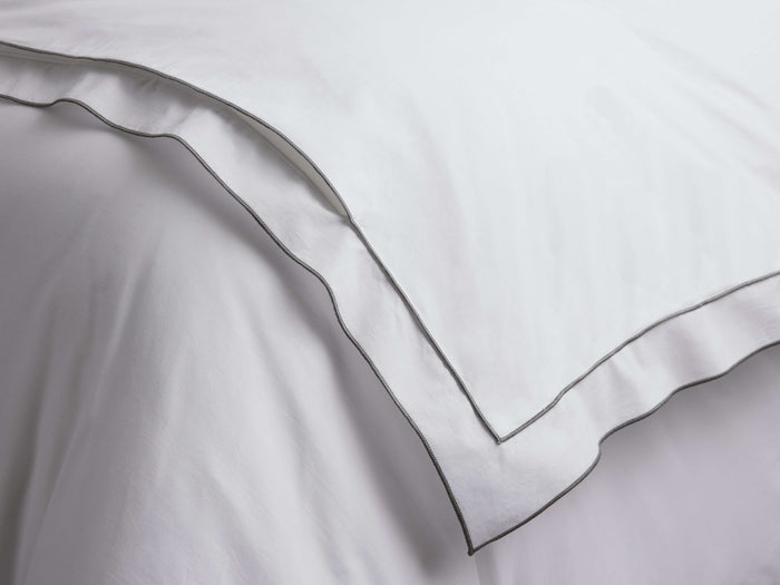 White Italian Embroidered Percale Duvet, folded, showcasing crisp fabric and dark grey embroidered borders.