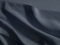 Dark blue Italian garment-dyed linen flat sheet, casually draped with natural folds, showing a subtle hemline stitch.