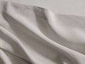 Italian Garment-Dyed Linen King Flat Sheet in Natural, casually draped, revealing soft folds, subtle texture, and a visible hem.