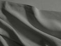 Charcoal Italian garment-dyed linen queen flat sheet, draped with soft wrinkles, highlighting its texture and a subtle hem.