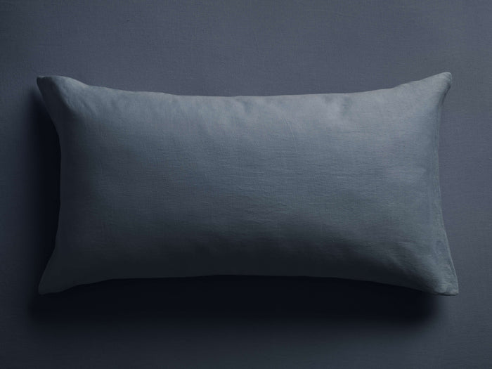 Horizontal muted blue Italian Garment-Dyed Linen Sham. Rectangular shape, soft, relaxed linen texture on a dark surface.