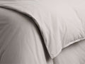 Close-up of a natural Italian Garment-Dyed Percale Duvet, showing soft folds and subtle, garment-dyed texture.