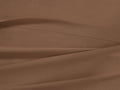 Clay Italian Garment-Dyed Percale Flat Sheet, draped with soft folds and a visible stitched hem, showing its rich, warm brown color.