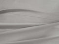 Light gray Italian Garment-Dyed Percale Flat Sheet, gently folded, revealing its soft texture and prominent top hem.