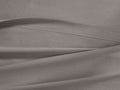 Close-up of a light gray Italian Garment-Dyed Percale Flat Sheet, draped with soft folds and a visible stitched hem.