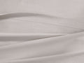 Natural Italian Garment-Dyed Percale Flat Sheet, draped with a visible 1 ??" hemline and fine stitching.