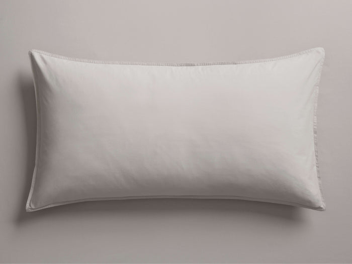 Natural Italian Garment-Dyed Percale King Sham, lying flat horizontally. Soft, light greyish-white fabric with subtle edge stitching.