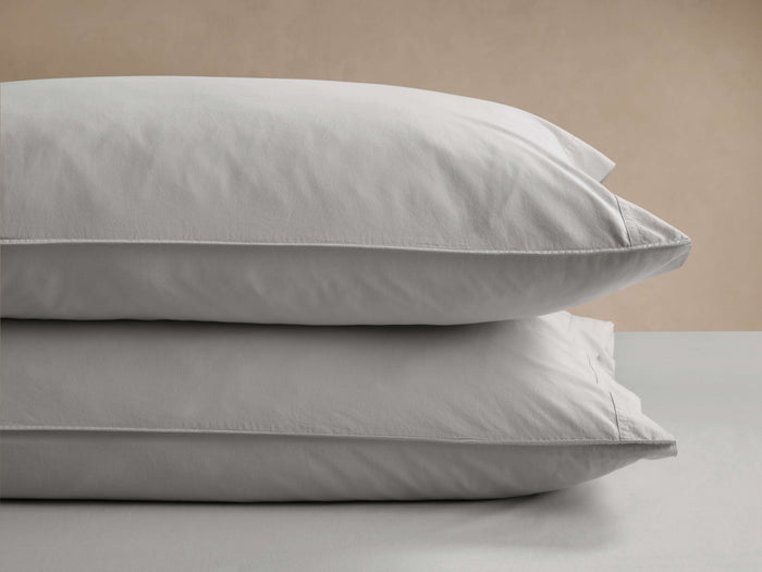 Set of 2 light gray Italian Garment-Dyed Percale Pillowcases, stacked showing soft texture, visible seams, on a neutral background.