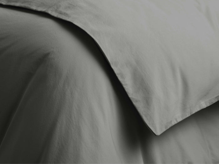 Close-up of charcoal Italian Garment-Dyed Sateen Duvet. Soft, draped fabric displays a subtle sheen & gentle, natural folds.