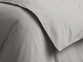 Close-up of light grey Italian Garment-Dyed Sateen Duvet, showing soft, subtly wrinkled fabric with a folded edge.