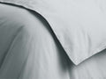 Close-up of a soft, sky blue Italian Garment-Dyed Sateen Duvet with subtle folds and a silky texture.