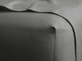 Close-up of a charcoal Italian Garment-Dyed Sateen Fitted Sheet, smooth and subtly lustrous, stretched over a mattress corner.