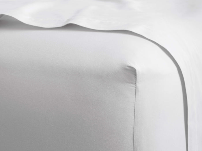 White Italian Garment-Dyed Sateen Fitted Sheet, showcasing a crisp, fitted corner and soft, subtle sheen.