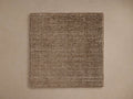 Jackson Rug Swatch, a textured square swatch of handwoven brown and white fibers, laid flat on a light beige surface.