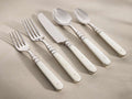 Front view of the Jimena Five Piece Place Setting, featuring polished stainless steel flatware with natural cream bone handles.