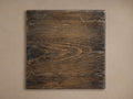 Square dark brown Kai Finish Board with wood grain texture and light scuff marks, against a beige background.