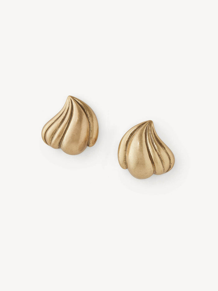 A pair of gold stud earrings with a ribbed, meringue-like textured design, displayed on a clean off-white background.