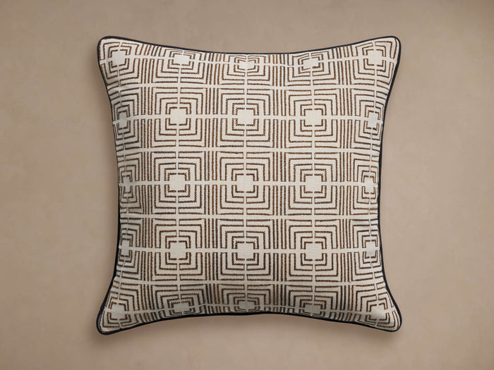 Kimble Pillow Cover, square, white with dark brown geometric pattern, black corded piping, on a beige background.