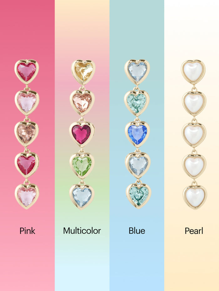 Heart-shaped earrings in pink, multicolor, blue, and pearl on a pastel background