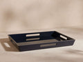 Dark blue high-gloss rectangular lacquer tray, angled view showing cutout handles on short sides.