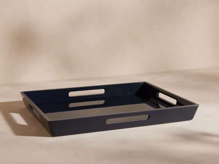 Dark blue high-gloss rectangular lacquer tray, angled view showing cutout handles on short sides.