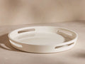 Creamy white high-gloss Lacquer Round Tray with integrated cut-out handles, viewed slightly from above on a light, neutral surface.