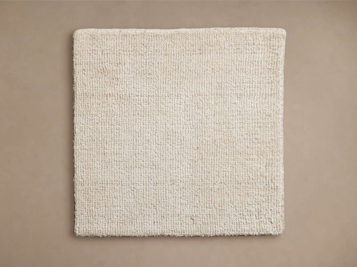 Lanning Rug Swatch in beige, square shape, textured weave, displayed on neutral background, showcasing color and construction.