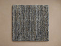 Lassen Handwoven Rug Swatch, square, flat lay. Features textured charcoal, grey, white, and tan woven fibers.