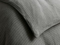Close-up of a textured grey Laviss Stripe Duvet with thin white vertical stripes, showing soft folds and creases.